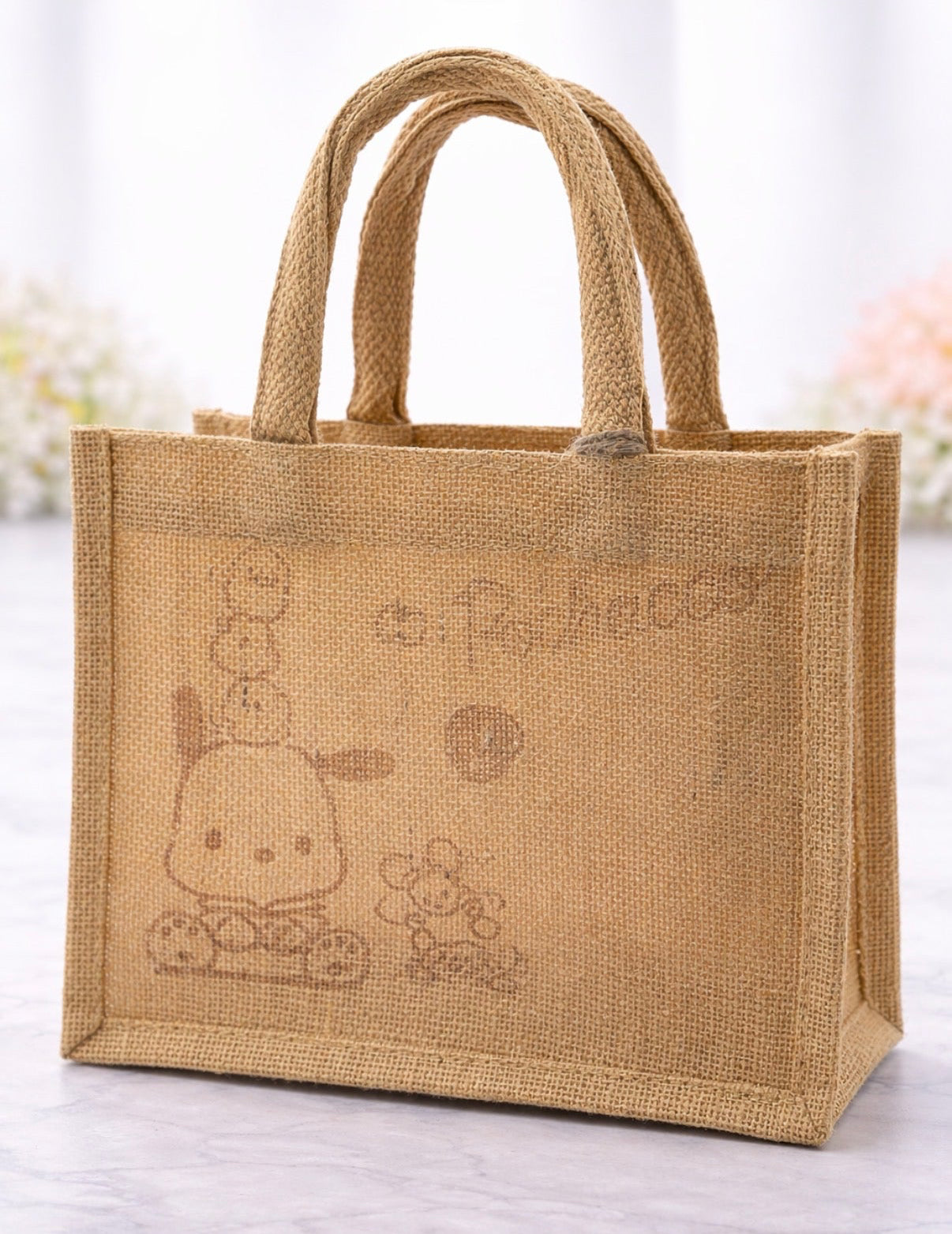 Jute bag with cartoon character design on a light background